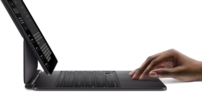iPad Pro paired with iPad Magic Keyboard, hand using touchpad